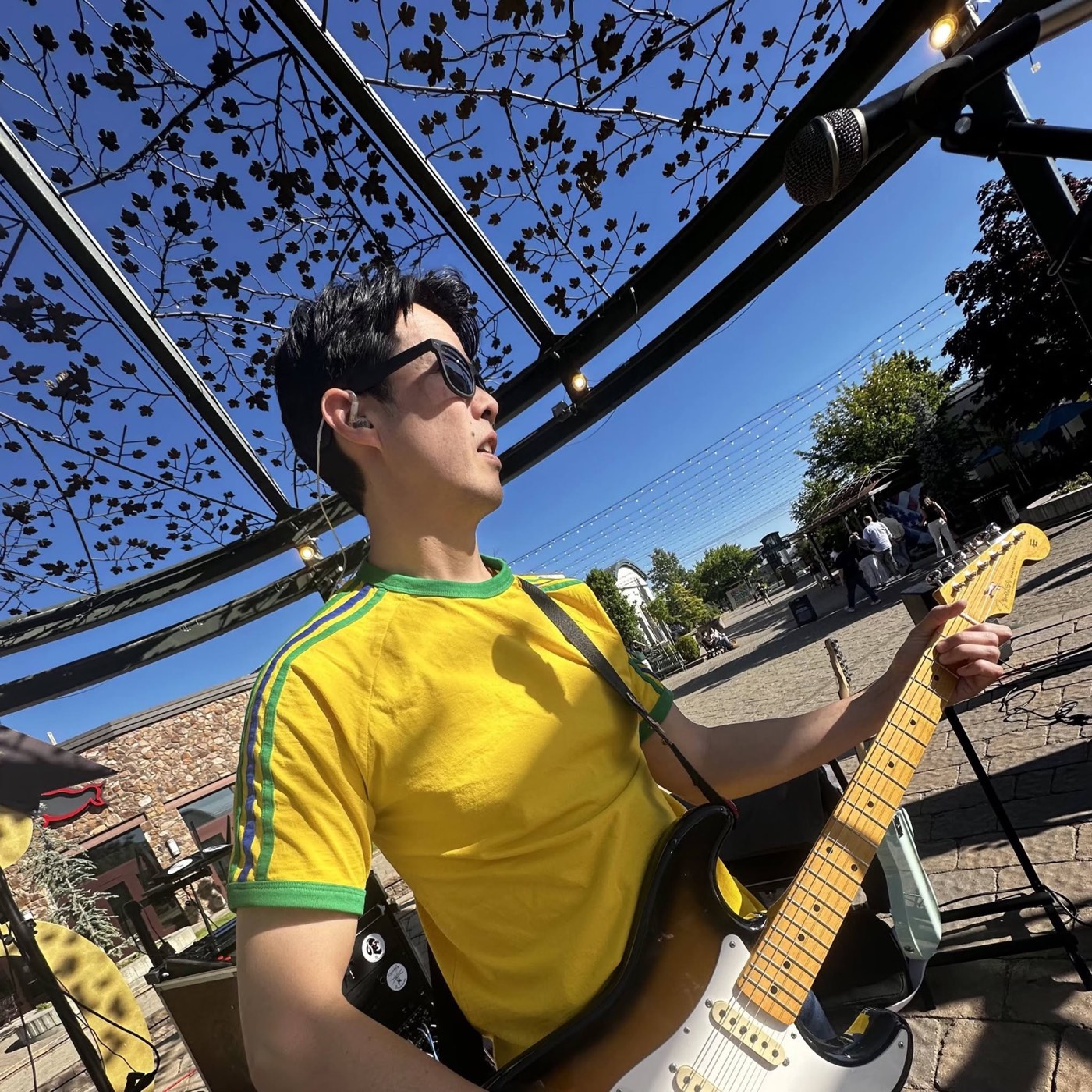 Aaron performing outdoors with a guitar