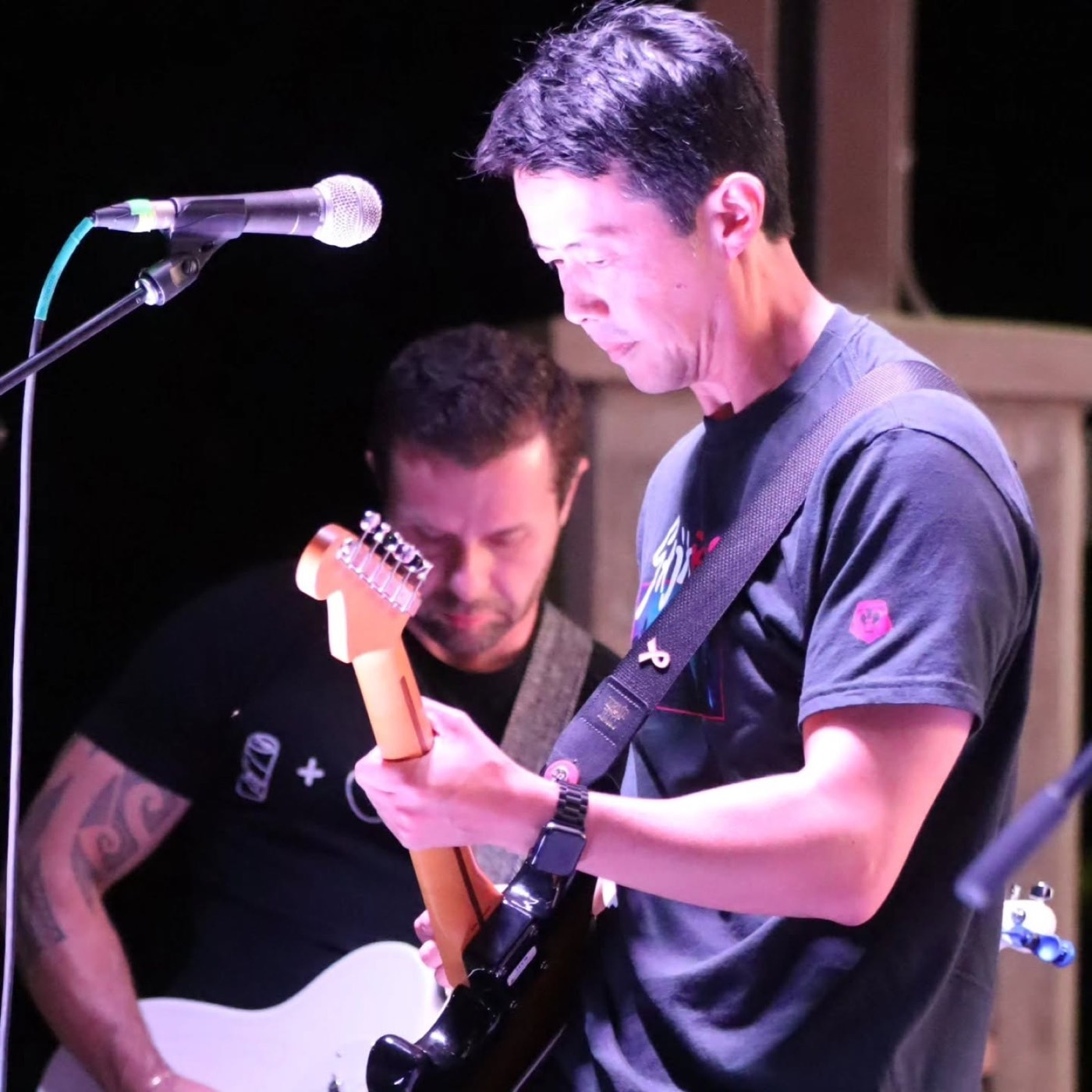Aaron performing on stage with a guitar